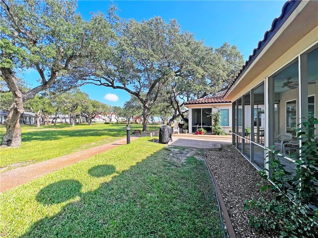 view of yard with a patio and a sunroom