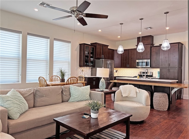 living room featuring visible vents, recessed lighting, a ceiling fan, and dark wood-style flooring