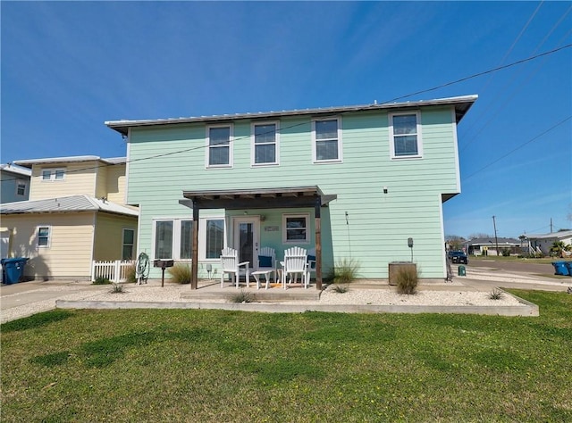 back of house with a yard and a patio