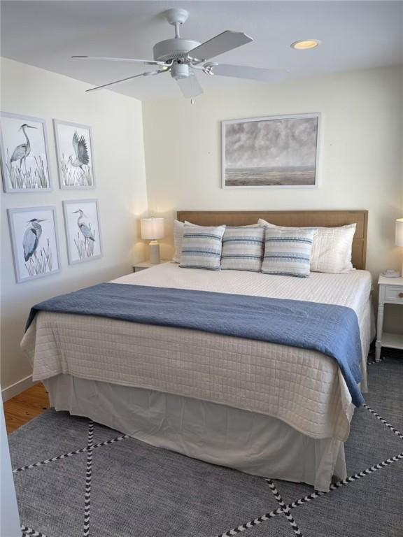 bedroom featuring dark hardwood / wood-style flooring and ceiling fan