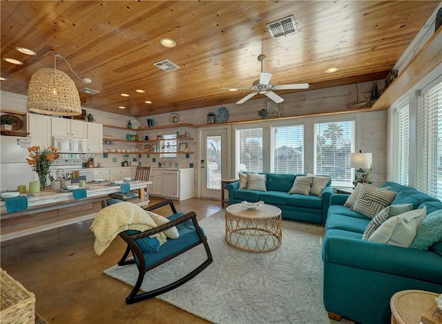 living room featuring ceiling fan, wood ceiling, and a healthy amount of sunlight