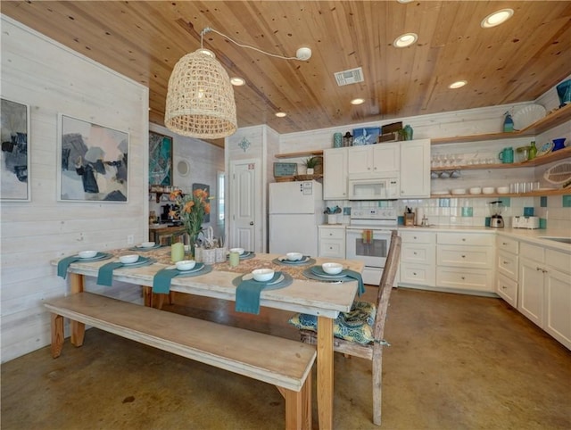 dining area with wooden walls and wooden ceiling