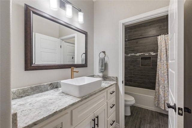 full bathroom featuring shower / bath combo, vanity, toilet, and wood finished floors