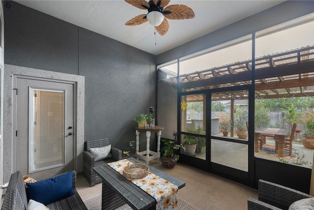 sunroom featuring a ceiling fan