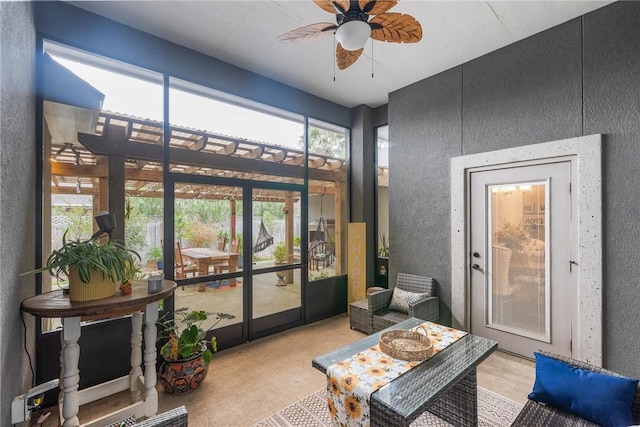 sunroom featuring ceiling fan