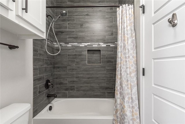 bathroom with shower / bath combo and toilet