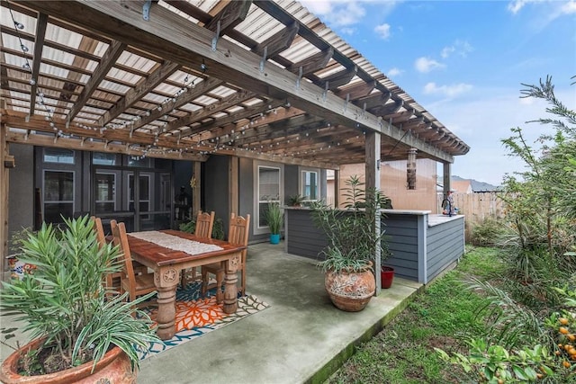 view of patio / terrace featuring outdoor dining area, fence, and a pergola