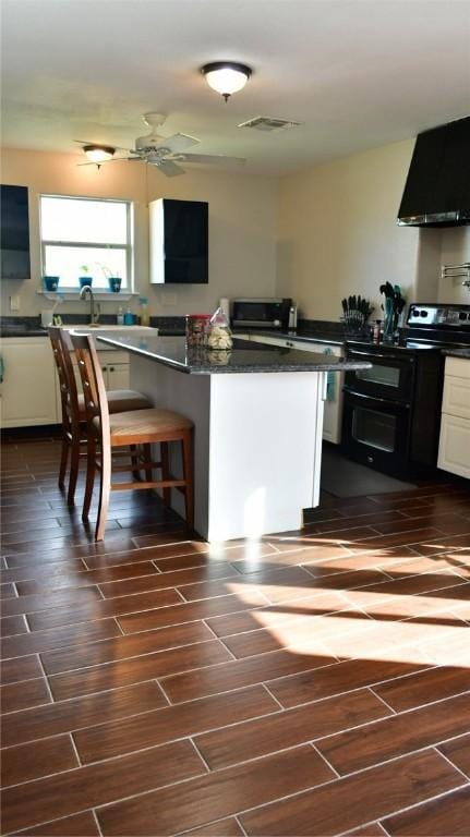 kitchen featuring white cabinets, electric range, extractor fan, and ceiling fan