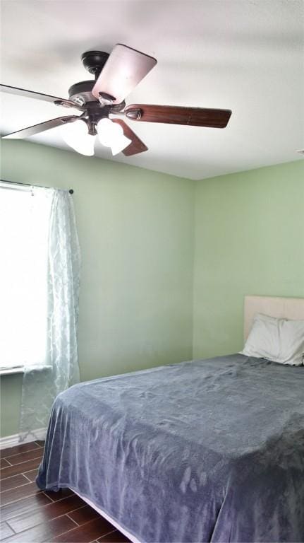 bedroom featuring ceiling fan and dark wood-type flooring