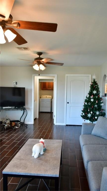 living room featuring dark hardwood / wood-style flooring and washer / clothes dryer