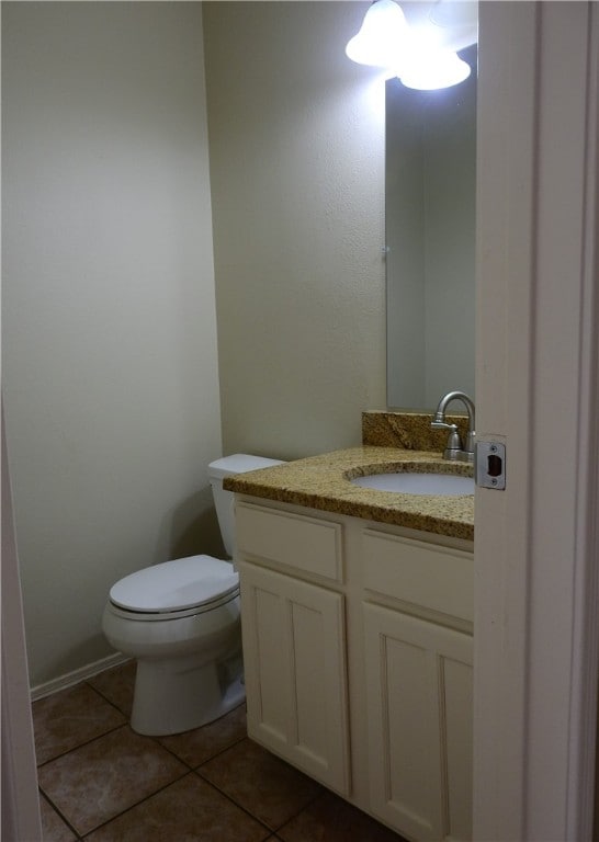 bathroom with vanity, tile patterned flooring, and toilet