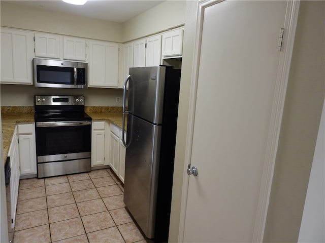 kitchen with white cabinetry, light tile patterned floors, light stone countertops, and stainless steel appliances