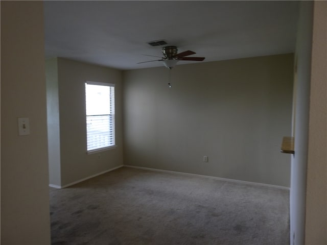 spare room featuring carpet and ceiling fan