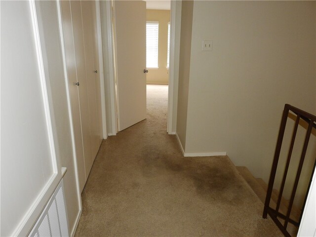 hallway featuring light colored carpet