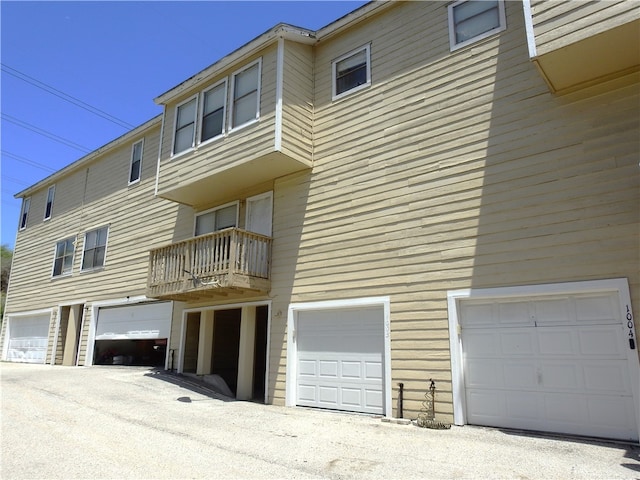 exterior space with a garage and a balcony