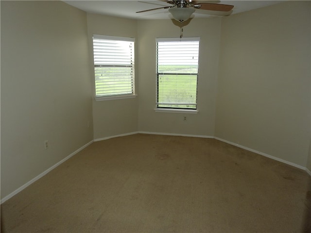 carpeted empty room featuring ceiling fan