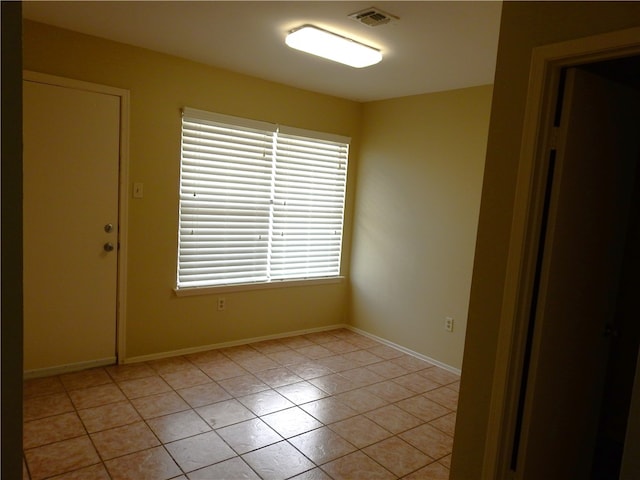 spare room featuring light tile patterned floors