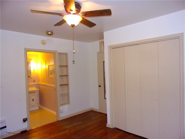 unfurnished bedroom featuring a closet, ceiling fan, dark hardwood / wood-style flooring, and ensuite bathroom