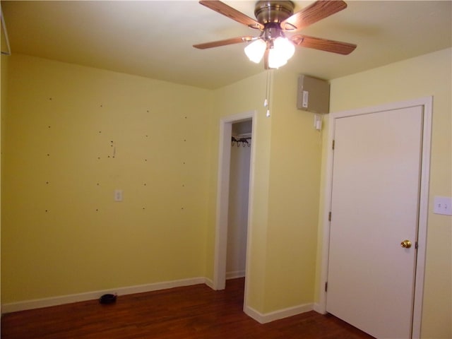 unfurnished bedroom with dark hardwood / wood-style flooring and ceiling fan