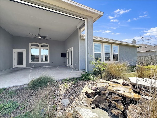 exterior space featuring stucco siding, a patio, and ceiling fan