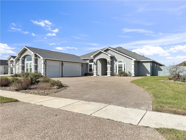 single story home featuring aphalt driveway, roof with shingles, an attached garage, and stucco siding