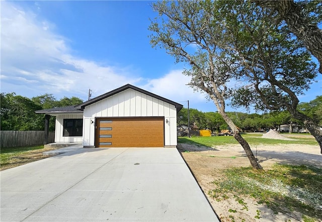 garage with fence and driveway