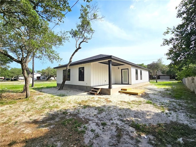 rear view of property featuring fence