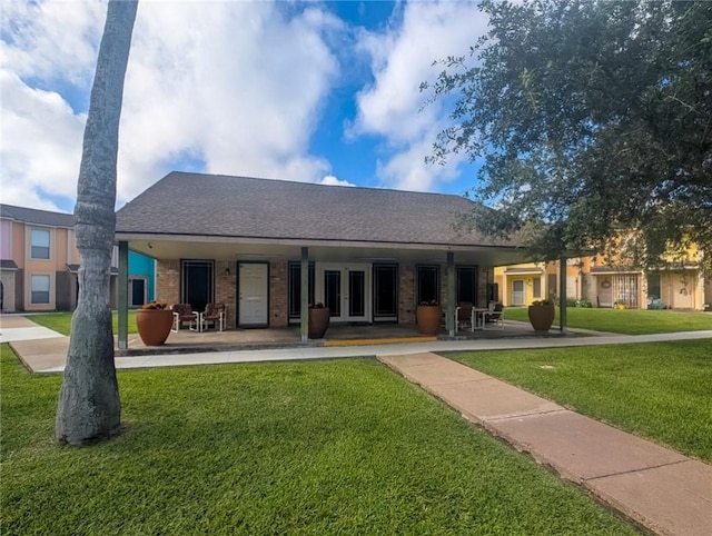 6702 Everhart Rd Unit 104, Corpus Christi, TX 78413 - rear view of property with a lawn, french doors, a shingled roof, and brick siding