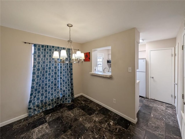 6702 Everhart Rd Unit 104, Corpus Christi, TX 78413 - dining area featuring a chandelier and baseboards