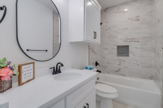 full bathroom with vanity, toilet, and tiled shower / bath