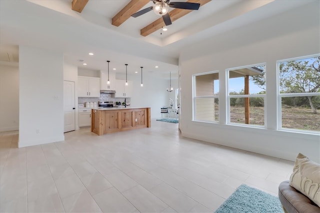 living room featuring beam ceiling, ceiling fan, and light tile patterned flooring