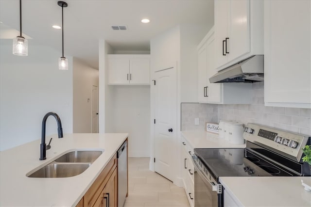 kitchen featuring decorative light fixtures, white cabinetry, sink, and stainless steel appliances