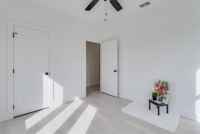 tiled bedroom featuring ceiling fan