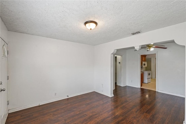 empty room featuring a textured ceiling, ceiling fan, and dark wood-type flooring