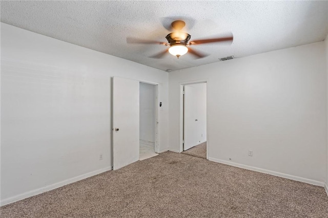 spare room with light carpet, a textured ceiling, and ceiling fan