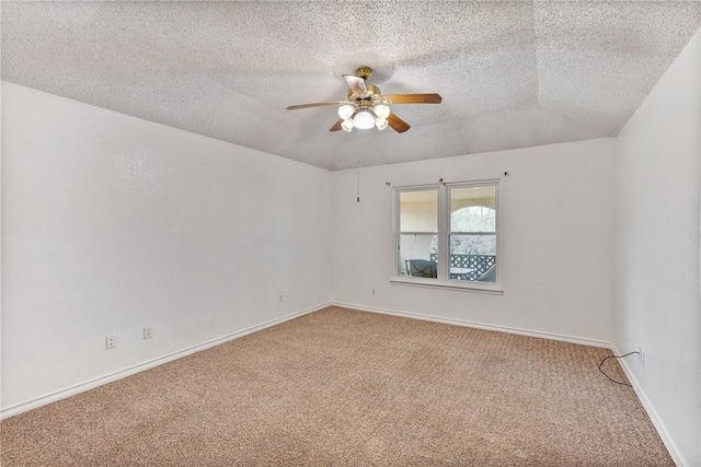 carpeted empty room with a ceiling fan, a textured ceiling, and baseboards