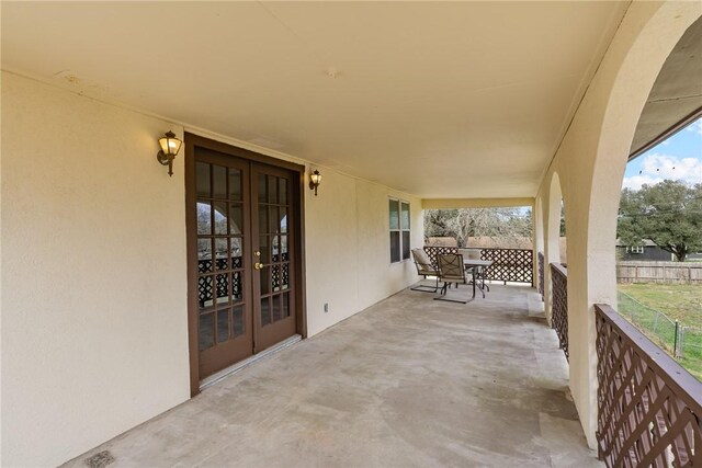 view of patio featuring fence and french doors