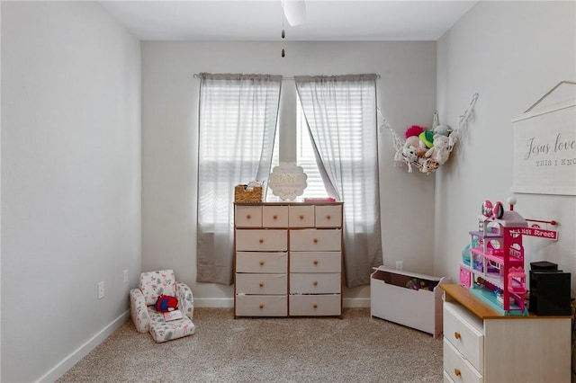 recreation room with light colored carpet