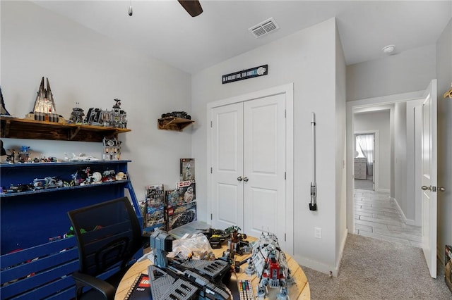 bedroom featuring light carpet, a closet, and ceiling fan