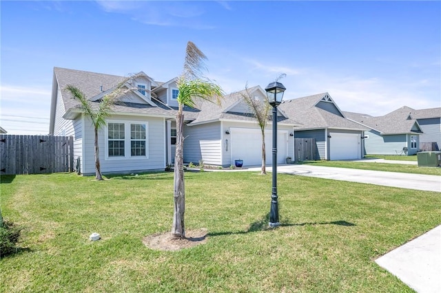 view of front of home with a front yard and a garage