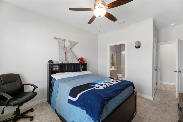 bedroom featuring ceiling fan, ensuite bathroom, and light carpet