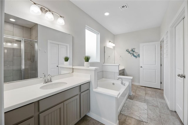 bathroom featuring vanity and separate shower and tub