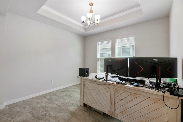 home office with a notable chandelier, ornamental molding, and a tray ceiling