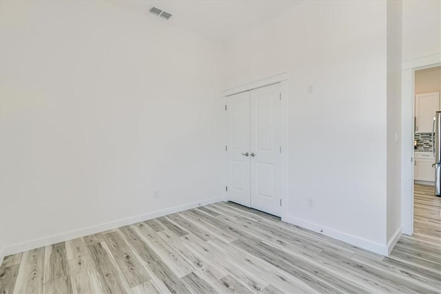 235 Port Mansfield St, Port Aransas, TX 78373 - spare room featuring light wood-style floors and baseboards