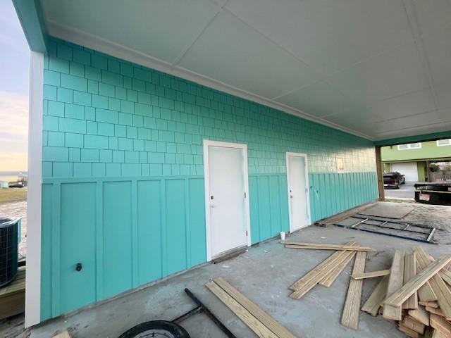 exterior space featuring cooling unit and concrete block siding