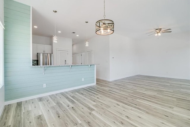 235 Port Mansfield St, Port Aransas, TX 78373 - unfurnished living room with light wood finished floors, recessed lighting, baseboards, and a ceiling fan