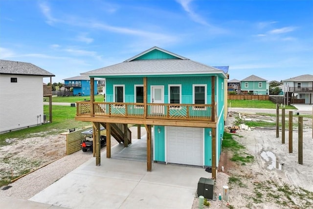 235 Port Mansfield St, Port Aransas, TX 78373 - beach home with an attached garage, driveway, a carport, roof with shingles, and a residential view