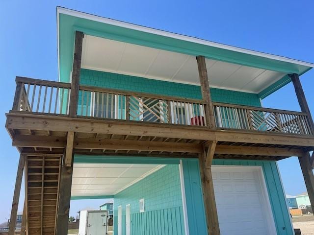 rear view of property featuring a garage