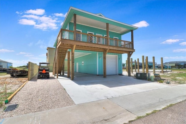 235 Port Mansfield St, Port Aransas, TX 78373 - raised beach house featuring an attached garage, driveway, and a carport