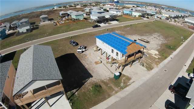bird's eye view featuring a water view and a residential view